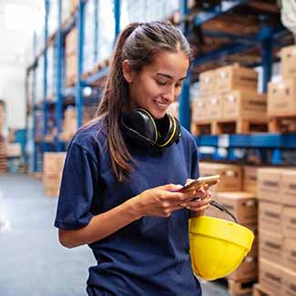 Woman in warehouse using phone